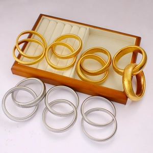 Stackable elastic titanium steel spring bracelets in gold and silver finish with wood box