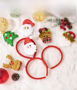 Detail of Christmas headband set featuring Santa, reindeer and sequins on snowy background