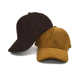Detail of knitted baseball caps with patterned jacquard texture in brown and yellow