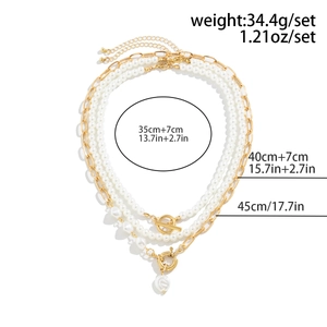 Detail of triple-layer faux pearl necklace with gold chain and heart pendant weight specs