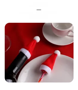 Festive mini Christmas hats used as wine bottle covers and lollipop holiday decorations