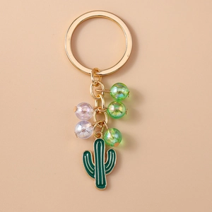 Detailed shot of green cactus enamel keychain with iridescent beads and golden chain