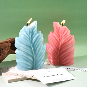 Detail van bladvormige geurkaarsen met delicate adertestructuren in blauwe en roze tinten