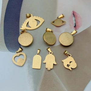 Set of 9 gold stainless steel charms featuring evil eye and heart shapes for DIY jewelry
