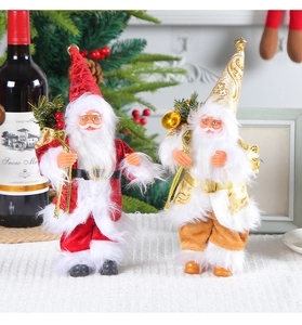 Detail of red and gold standing Santa Claus figurines with sequins and gift bags