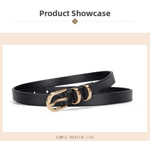 Detailed close-up of a slim black leather belt with golden metal buckle and dual rings