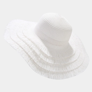 Detail of white straw sun hat featuring a 15cm wide brim and decorative fringe edges