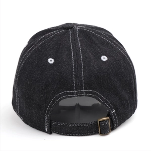 Detail of washed denim baseball cap back with contrast stitching and adjustable metal buckle