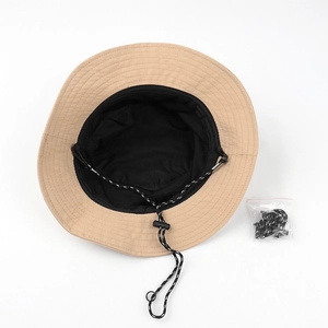 Flat lay of khaki bucket hat showing black mesh lining and adjustable windproof rope
