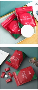 Macro shot of individually wrapped portable compressed towels in diverse sizes and packaging