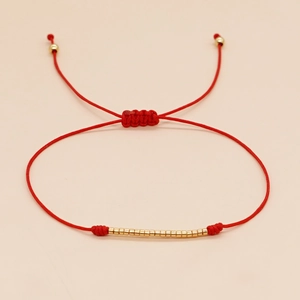 Handmade red string bracelet with gold beads and adjustable closure for women