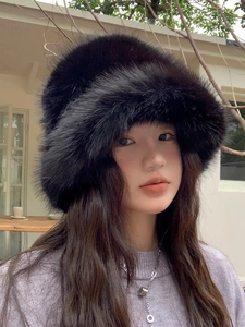 Dettaglio di un cappello di peluche nero in finta pelliccia su modella all'aperto