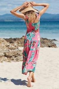 Detail of bohemian floral maxi dress with smocked back and vibrant pink tropical prints