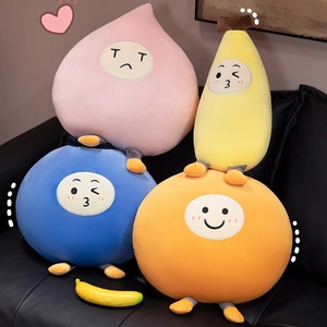 Cute fruit plush pillows with creative facial expressions on a cozy black leather sofa