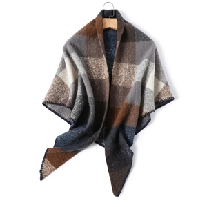 Close-up of color block plaid shawl with premium wool blend texture and navy blue trim