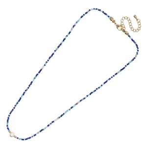 Handmade bohemian blue beaded necklace with a central white pearl and gold clasp