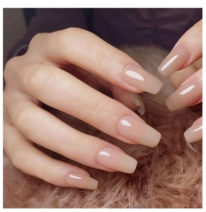 Glossy nude pink long square nails with a translucent jelly finish on a plush background