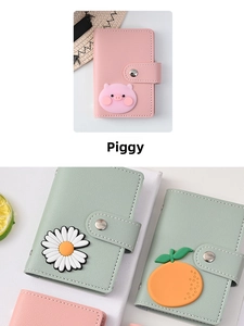 Close-up of pink piggy card holder with button closure and high-quality lychee texture