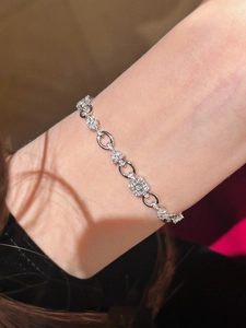 Close-up of elegant zircon paved silver chain bracelet with square crystal centerpiece