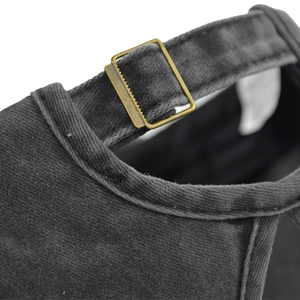 Detail view of adjustable metal slide buckle on vintage distressed ponytail baseball cap
