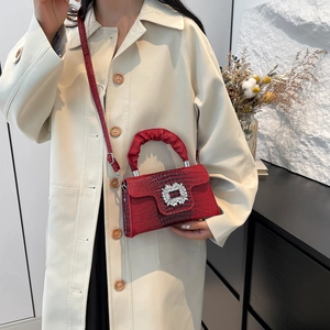 Red crocodile texture shoulder bag with sparkling silver square buckle on a model