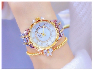 Detail of two-tone women's watch with crystal bezel and matching bow bracelet