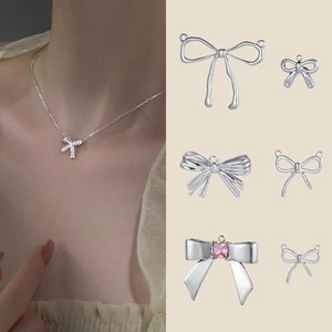 Silver stainless steel bow pendant collection with pink gemstone on model and flat lay