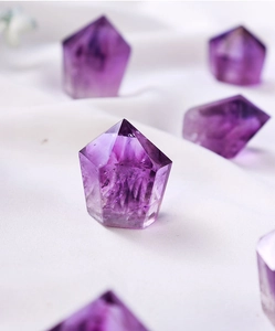 Macro view of natural purple amethyst hexagonal pillars with internal ice crack textures