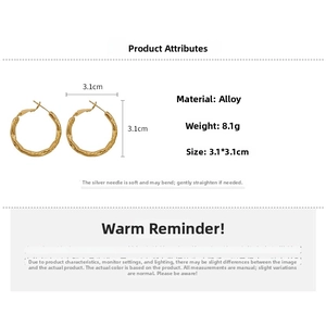 Detail view of gold irregular bamboo-textured hoop earrings with S925 silver needles