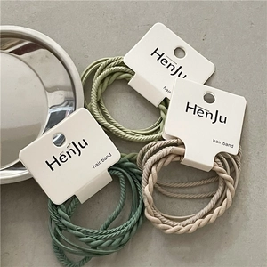 Braided elastic hair band set in sage green, olive, and khaki tones on grey texture
