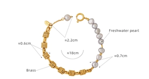 Detailed view of brass chain bracelet with gray freshwater pearls and BIX tag