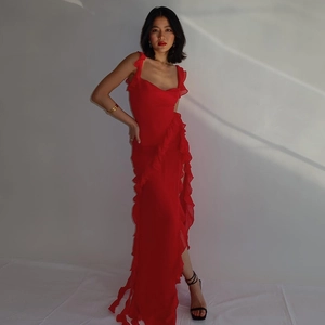Detail of red backless dress showing elegant ruffle trim and sexy side split leg design