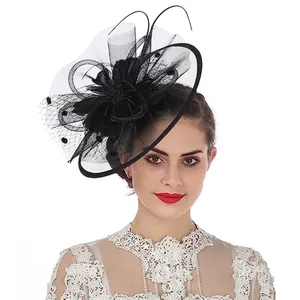 Detail of vintage black mesh veil hat with elegant feathers and beadwork on a model