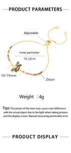 Close-up of golden bee bracelet with colorful zircons and adjustable sliding chain buckle