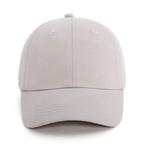 Detail view of a six-panel light beige kids cotton baseball cap with ventilation eyelets