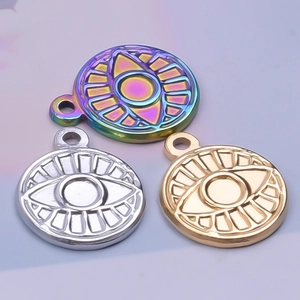 Macro shot of evil eye pendants in rainbow, silver, and gold stainless steel finishes