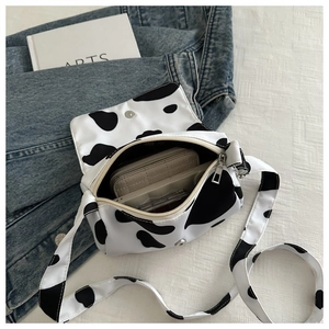 Detail view of mini cow print canvas crossbody bag showing inner storage capacity