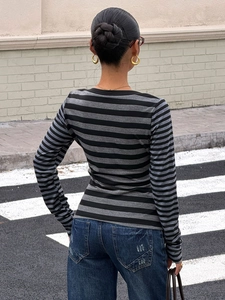 Rear view of women's casual striped long sleeve shirt with black and grey pattern detail