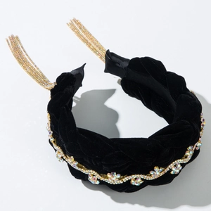 Macro view of velvet braided headband with golden rhinestone chain and long tassels