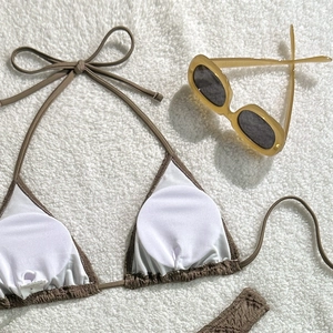 Detail of dark brown ruched bikini top with removable pads and halter ties on fur
