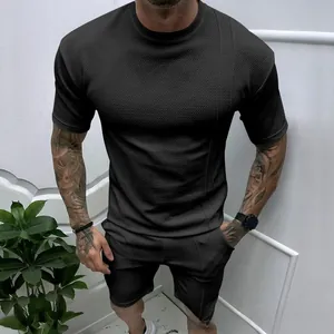 Close-up of black men's summer set featuring textured waffle fabric and a round neck design