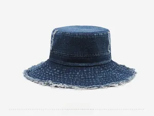 Detail view of the back of a vintage dark blue denim bucket hat with frayed raw edges