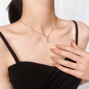 18k gold plated stainless steel necklace featuring a light green oval cat eye stone pendant