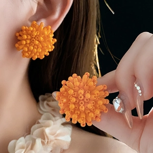 Vibrant orange beaded ball stud earrings made from micro beads on a silver needle base
