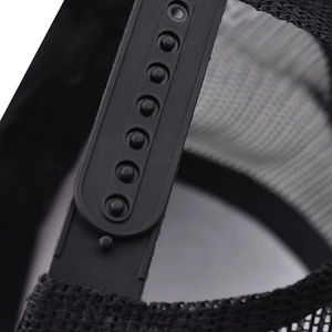Detail of adjustable snapback closure and breathable mesh fabric on black trucker cap