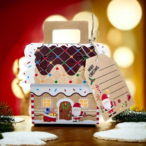 Detail of kraft paper gingerbread house gift box with festive Merry Christmas tag