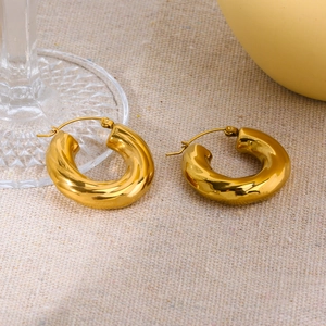 Polished 18K gold plated stainless steel chunky C-shaped hoop earrings on linen cloth