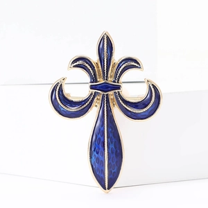 Vintage gold-plated lily flower brooch with navy blue enamel texture on white background