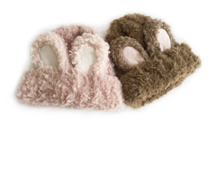 Detailed close-up of pink and brown plush knit hats with cute fluffy rabbit ears