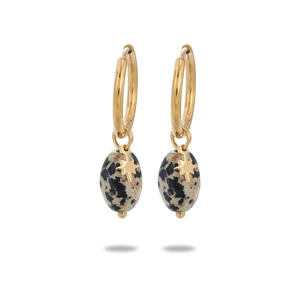 Detail view of gold octagram star earrings with oval dalmatian jasper stone beads